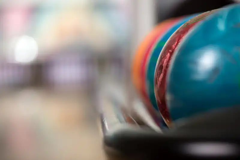 Club 55 Banner Focused ball on a colorful alley, anticipation for a thrilling bowling match